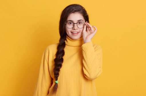 happy-smiling-excited-young-woman-with-pigtail-wearing-yellow-shirt_176532-10483